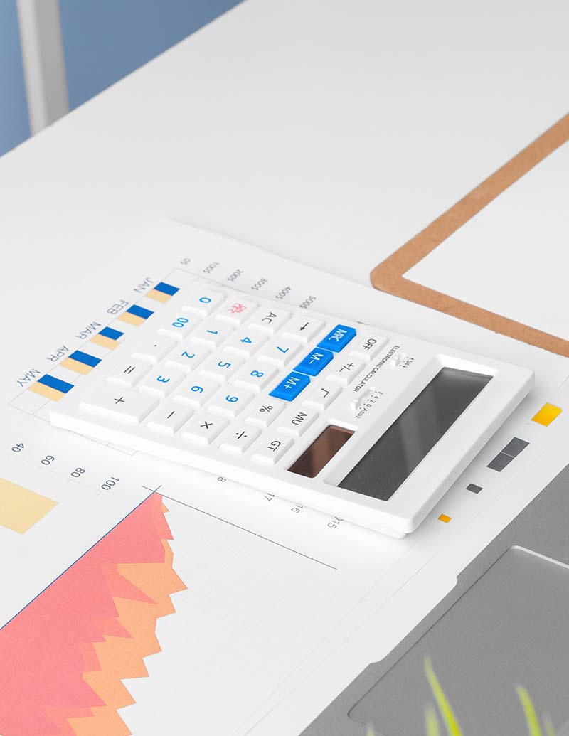 Calculator and recruitment business performance graphs for financial planning